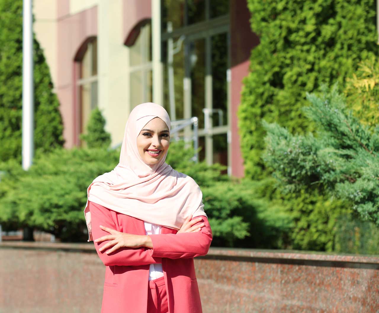 Woman in pink hijab with green background