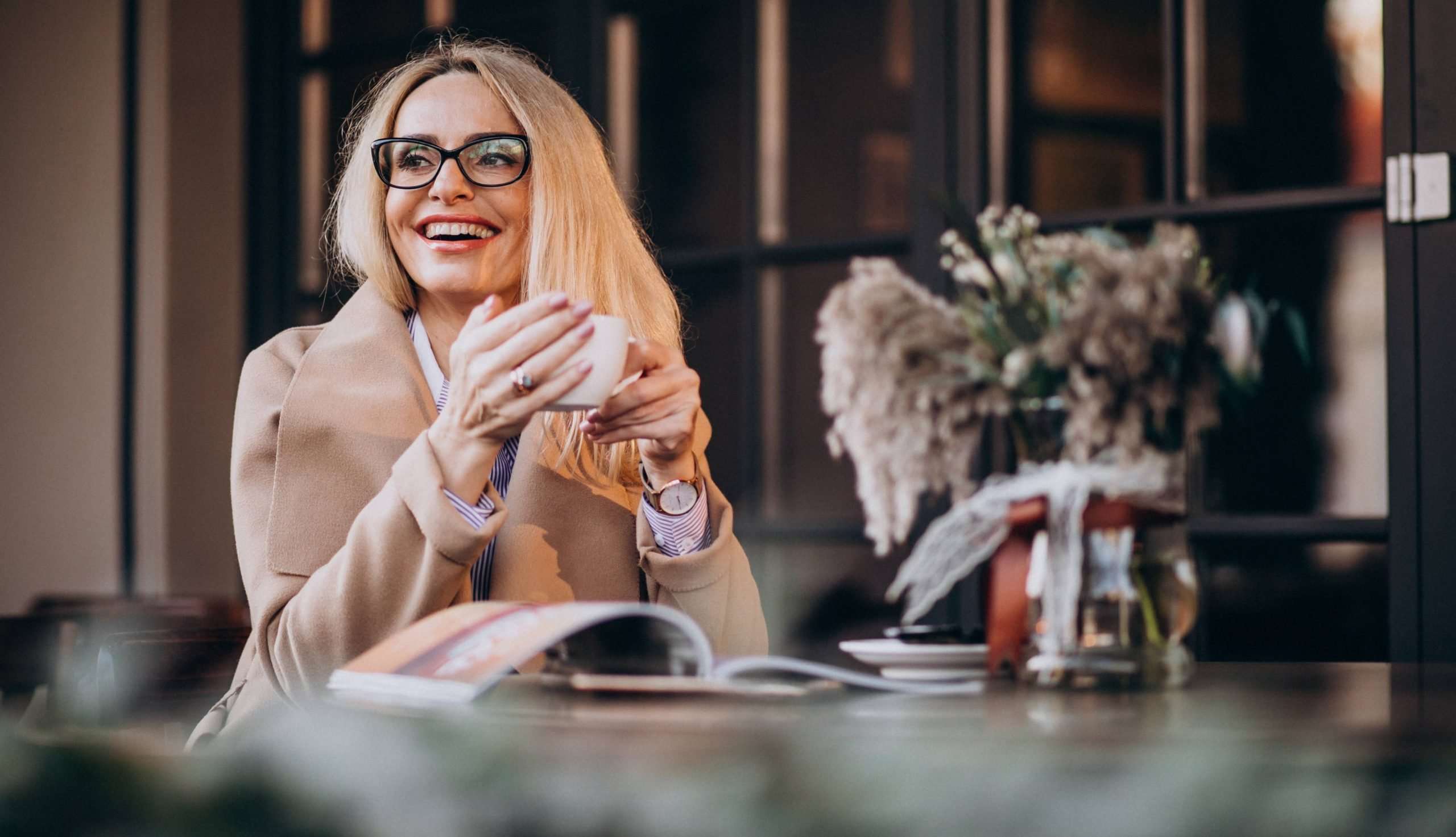 Woman in glasses enjoying coffee