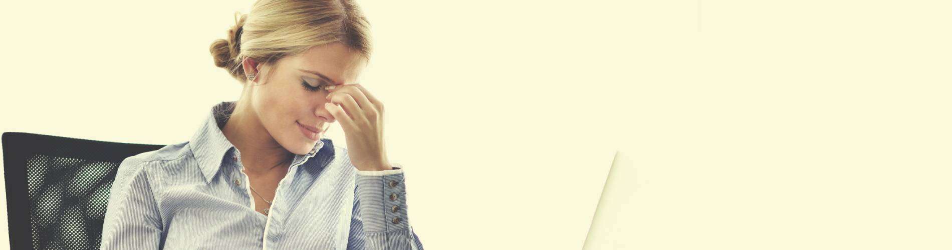 Woman in blue shirt feeling stressed.