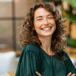 Smiling woman in green top indoors